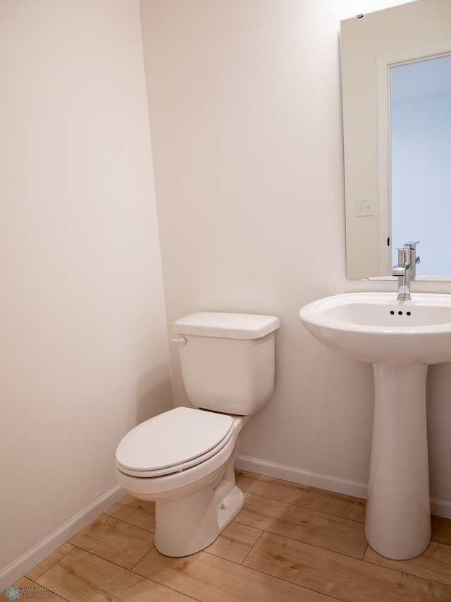 7901 Lost River Rd, Horace, ND 58047 - half bath with wood finished floors and toilet