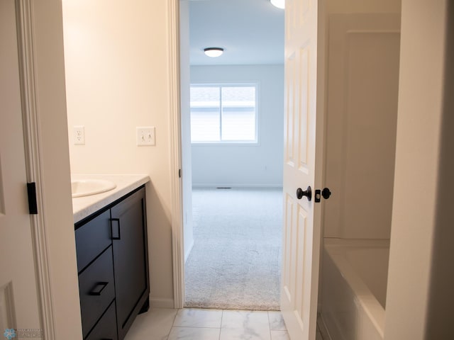 7901 Lost River Rd, Horace, ND 58047 - bathroom with vanity, a bathtub, and marble look tiles