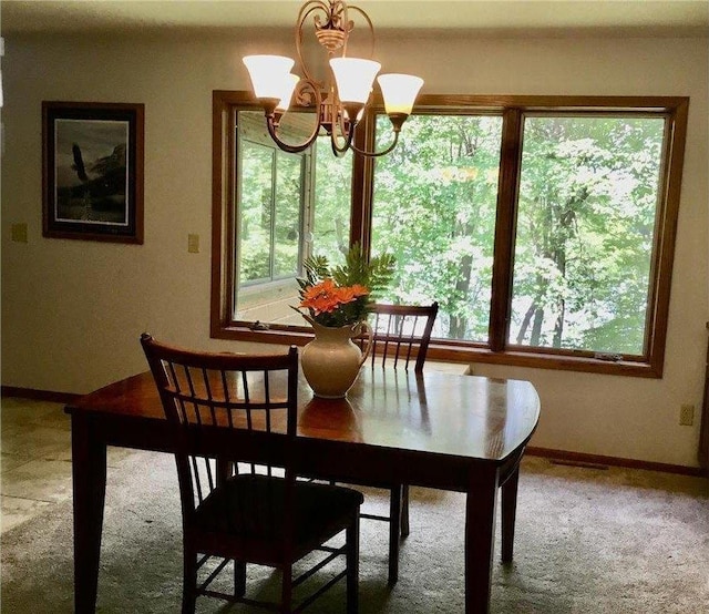 17136 Hidden Lake Rd, Fifty Lakes, MN 56448 - carpeted dining area with a chandelier and baseboards