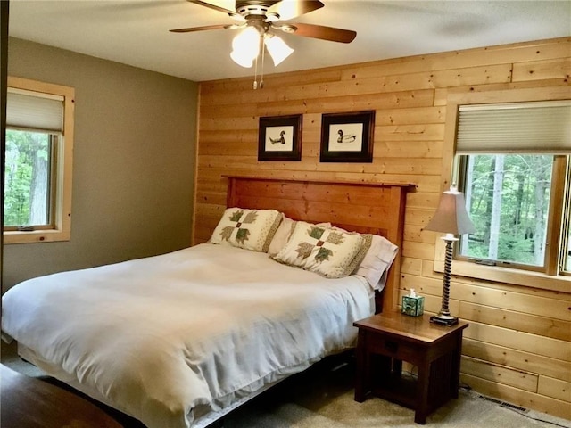 17136 Hidden Lake Rd, Fifty Lakes, MN 56448 - bedroom with wood walls and ceiling fan