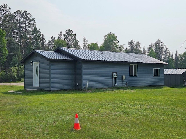 10091 Trengove Rd NW, Bemidji, MN 56601 - back of house with a lawn and a metal roof