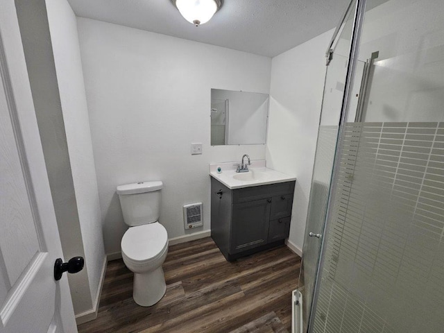 10091 Trengove Rd NW, Bemidji, MN 56601 - bathroom with wood finished floors, vanity, a stall shower, and heating unit
