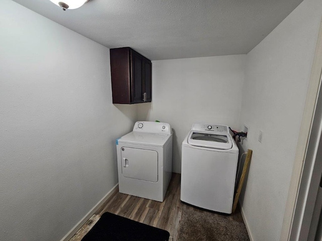 10091 Trengove Rd NW, Bemidji, MN 56601 - laundry room with cabinet space, washer and dryer, dark wood-style floors, and a textured ceiling