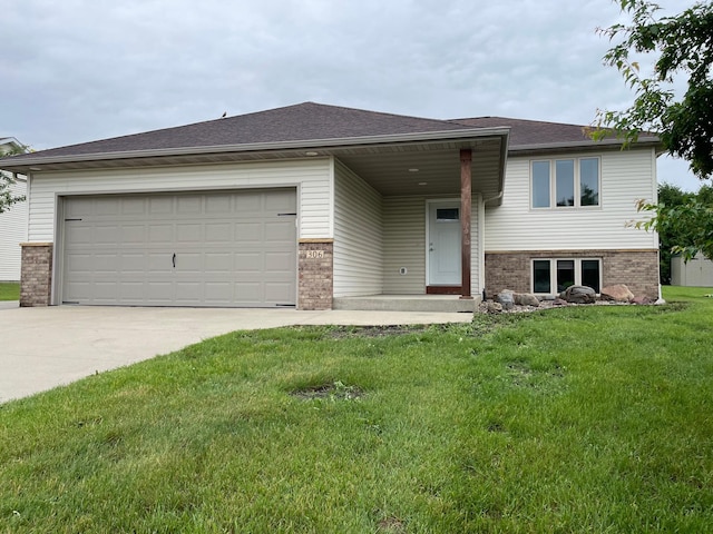 306 10th Ave NW, Dodge Center, MN 55927 - view of front facade with brick siding, concrete driveway, a front yard, an attached garage, and a shingled roof