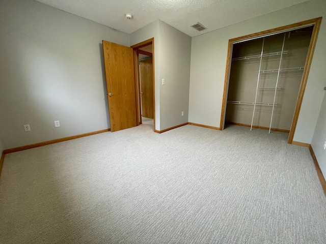 306 10th Ave NW, Dodge Center, MN 55927 - unfurnished bedroom with a closet, carpet, and a textured ceiling