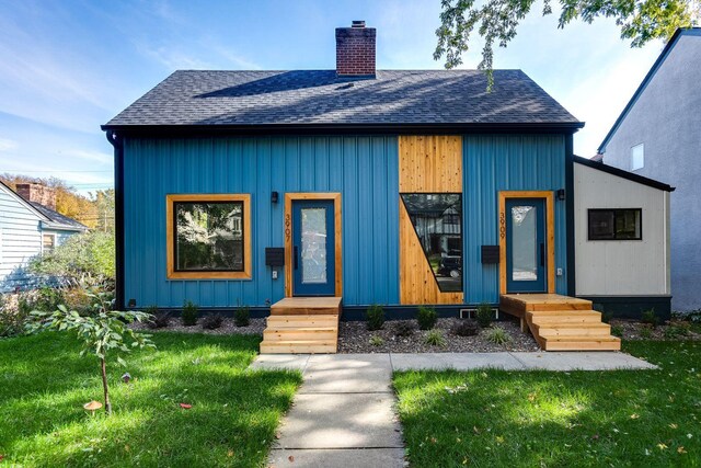 3909 Xerxes Ave S, Minneapolis, MN 55410 - view of front of home featuring a chimney, roof with shingles, and a front lawn