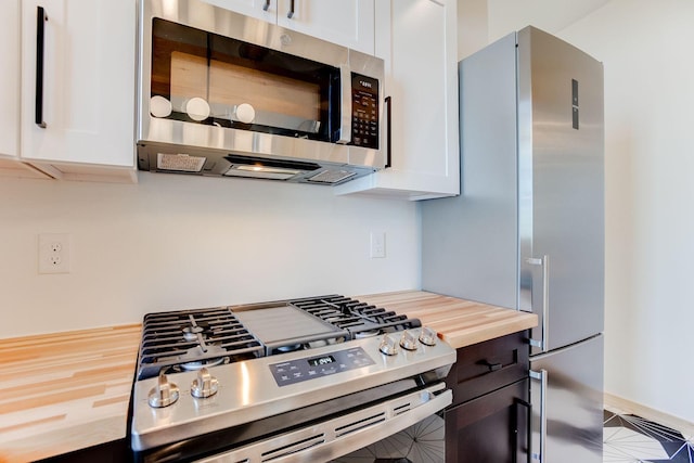 3909 Xerxes Ave S, Minneapolis, MN 55410 - kitchen with stainless steel appliances, butcher block counters, and white cabinets