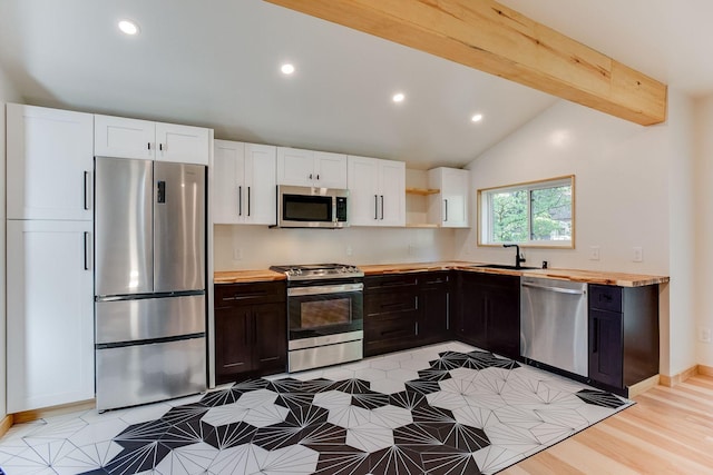 3909 Xerxes Ave S, Minneapolis, MN 55410 - kitchen with stainless steel appliances, white cabinets, butcher block countertops, open shelves, and recessed lighting