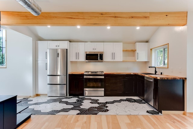 3909 Xerxes Ave S, Minneapolis, MN 55410 - kitchen featuring appliances with stainless steel finishes, white cabinets, light wood-type flooring, open shelves, and recessed lighting
