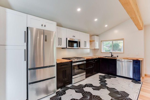 3909 Xerxes Ave S, Minneapolis, MN 55410 - kitchen featuring stainless steel appliances, butcher block countertops, recessed lighting, white cabinetry, and open shelves