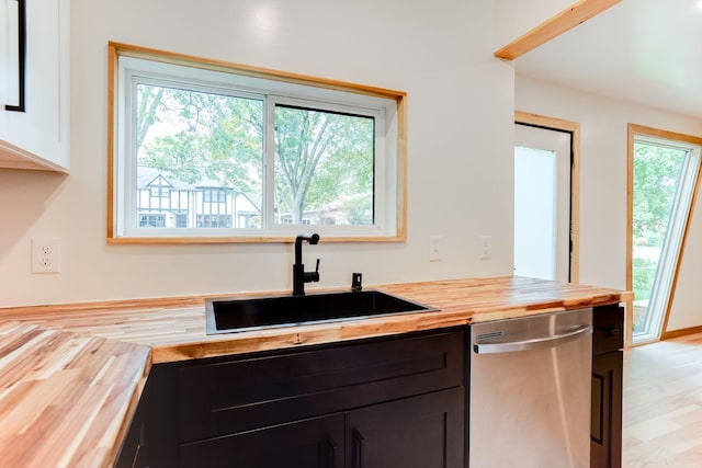 3909 Xerxes Ave S, Minneapolis, MN 55410 - kitchen with butcher block countertops, stainless steel dishwasher, and light wood-style floors
