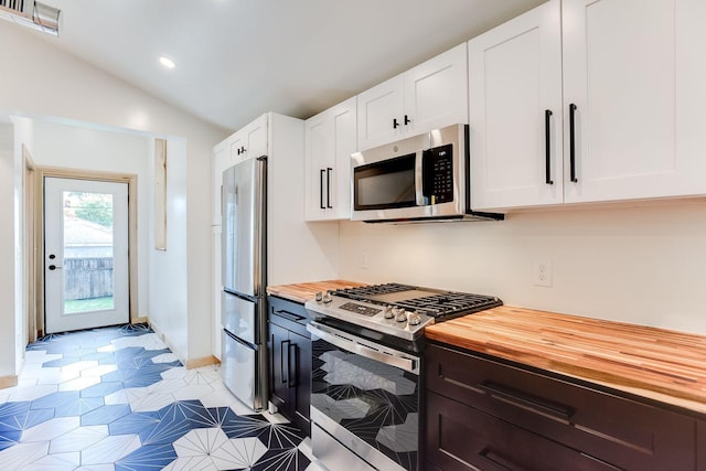 3909 Xerxes Ave S, Minneapolis, MN 55410 - kitchen with appliances with stainless steel finishes, butcher block countertops, white cabinets, lofted ceiling, and recessed lighting