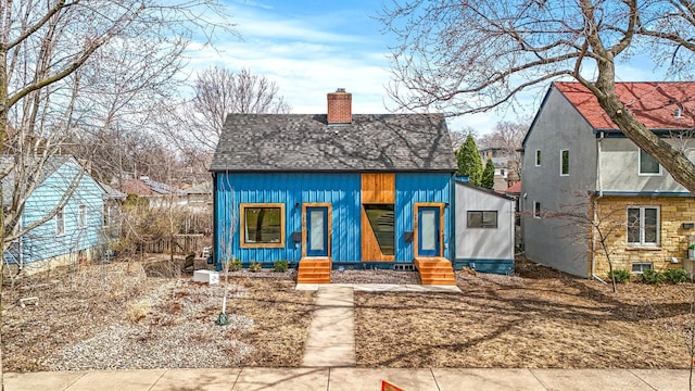 3909 Xerxes Ave S, Minneapolis, MN 55410 - bungalow featuring a chimney, roof with shingles, and entry steps