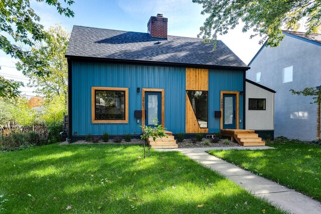 3909 Xerxes Ave S, Minneapolis, MN 55410 - view of front of property with a chimney, a shingled roof, and a front yard