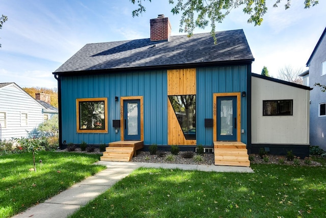 3909 Xerxes Ave S, Minneapolis, MN 55410 - view of front of house with roof with shingles, a chimney, a front yard, and board and batten siding
