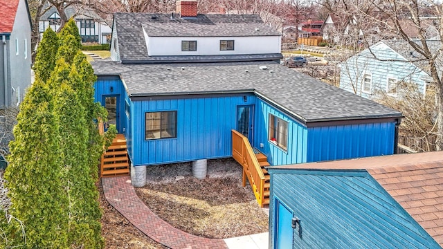 3909 Xerxes Ave S, Minneapolis, MN 55410 - rear view of house featuring a shingled roof, board and batten siding, and a chimney