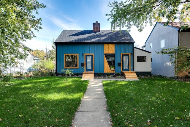 3909 Xerxes Ave S, Minneapolis, MN 55410 - view of front facade with a chimney, a front yard, and roof with shingles