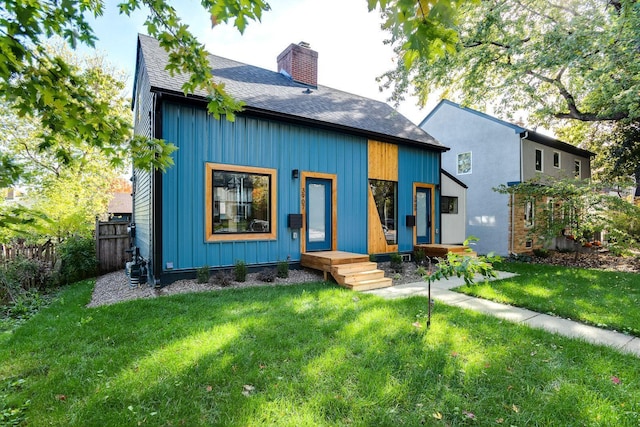 3909 Xerxes Ave S, Minneapolis, MN 55410 - view of front facade featuring a shingled roof, a chimney, and board and batten siding