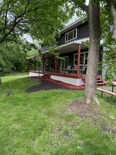 40815 Shadow Dr, Clitherall, MN 56524 - back of property featuring a lawn and covered porch