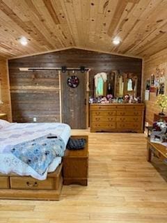 40815 Shadow Dr, Clitherall, MN 56524 - bedroom with wooden walls, wood finished floors, vaulted ceiling, and wooden ceiling