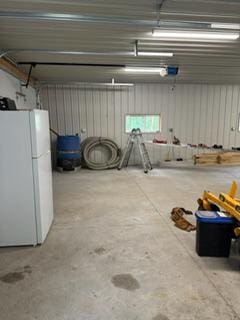 40815 Shadow Dr, Clitherall, MN 56524 - garage with freestanding refrigerator and a garage door opener