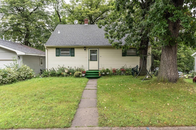 505 1st Ave SE, Pelican Rapids, MN 56572 - new england style home featuring a front lawn, a chimney, a shingled roof, and entry steps