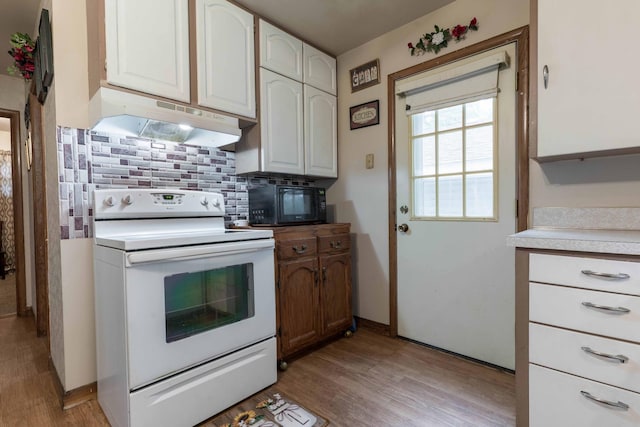 505 1st Ave SE, Pelican Rapids, MN 56572 - kitchen with white electric range, under cabinet range hood, black microwave, backsplash, and light wood finished floors