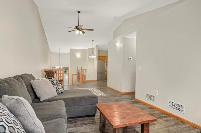 2721 230th Ct NW, Saint Francis, MN 55070 - living room featuring vaulted ceiling, wood finished floors, a ceiling fan, and a chandelier