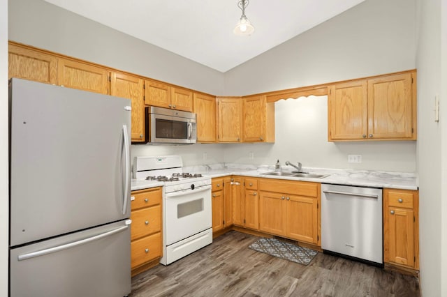 2721 230th Ct NW, Saint Francis, MN 55070 - kitchen with stainless steel appliances, light countertops, vaulted ceiling, and dark wood-type flooring