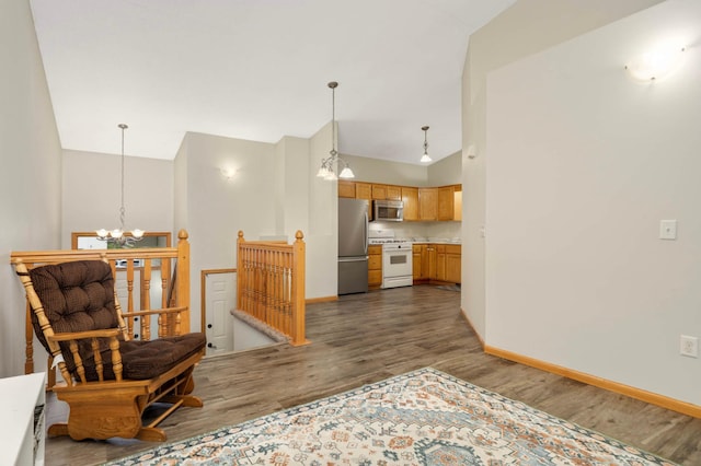 2721 230th Ct NW, Saint Francis, MN 55070 - kitchen featuring appliances with stainless steel finishes, a chandelier, dark wood-style flooring, light countertops, and decorative light fixtures
