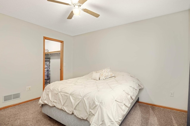 2721 230th Ct NW, Saint Francis, MN 55070 - carpeted bedroom with a walk in closet, a closet, and a ceiling fan