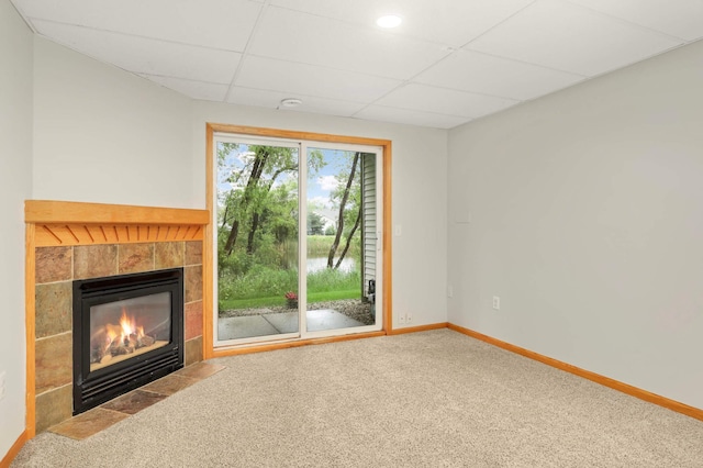 2721 230th Ct NW, Saint Francis, MN 55070 - unfurnished living room with carpet flooring, a paneled ceiling, a tiled fireplace, and a water view