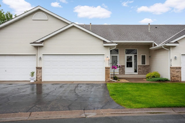 2721 230th Ct NW, Saint Francis, MN 55070 - view of front facade with brick siding, driveway, a front yard, roof with shingles, and a garage