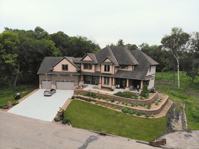 716 169th Ln NE, Ham Lake, MN 55304 - view of front facade with concrete driveway, a front yard, a porch, and an attached garage