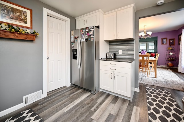 231 Mark St, Winona, MN 55987 - kitchen featuring stainless steel refrigerator with ice dispenser, dark wood-style flooring, a chandelier, and white cabinetry