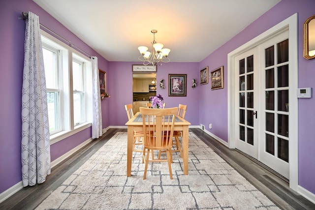 231 Mark St, Winona, MN 55987 - dining space with a chandelier, wood finished floors, and french doors