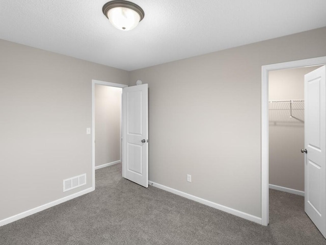9773 32nd St NE, Saint Michael, MN 55376 - unfurnished bedroom with carpet flooring, a walk in closet, and a closet