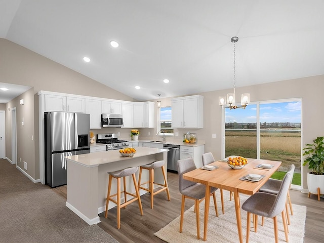 9773 32nd St NE, Saint Michael, MN 55376 - kitchen with stainless steel appliances, lofted ceiling, a center island, a chandelier, and white cabinetry