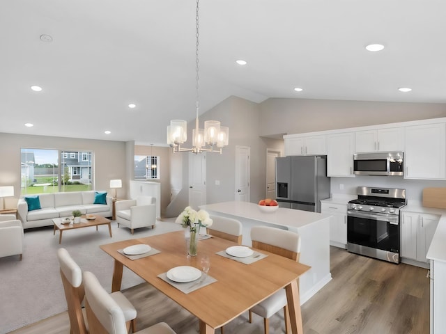 9773 32nd St NE, Saint Michael, MN 55376 - dining area featuring light wood-style flooring, a chandelier, lofted ceiling, and recessed lighting