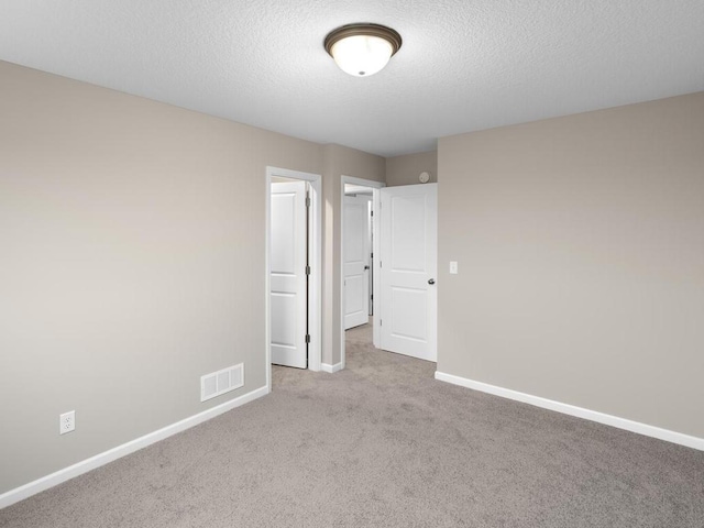 9773 32nd St NE, Saint Michael, MN 55376 - unfurnished bedroom with carpet floors and a textured ceiling