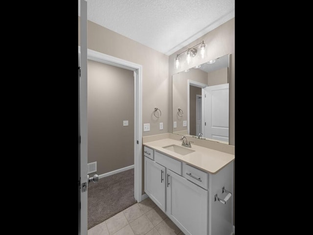 9773 32nd St NE, Saint Michael, MN 55376 - bathroom featuring vanity, a textured ceiling, and tile patterned floors