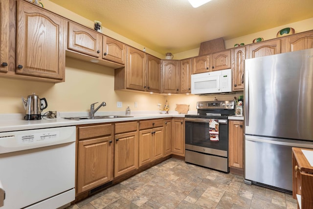 1715 Aspen Ln, Fergus Falls, MN 56537 - kitchen featuring appliances with stainless steel finishes, stone finish floors, light countertops, and brown cabinets