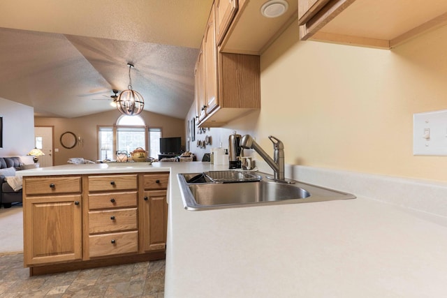 1715 Aspen Ln, Fergus Falls, MN 56537 - kitchen featuring open floor plan, a peninsula, vaulted ceiling, light stone finish flooring, and light countertops