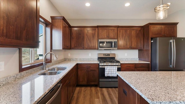 991 45th Ave NE, Saint Cloud, MN 56304 - kitchen featuring appliances with stainless steel finishes, dark wood-type flooring, light stone countertops, recessed lighting, and hanging light fixtures