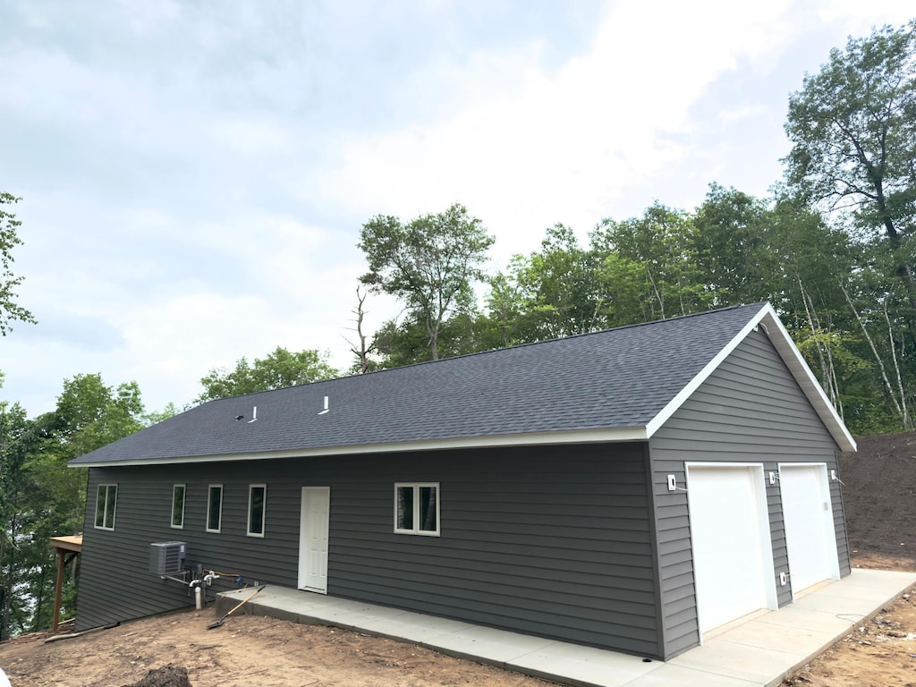 17541 Mitchell Lake Rd, Fifty Lakes, MN 56448 - rear view of property with a shingled roof and a detached garage