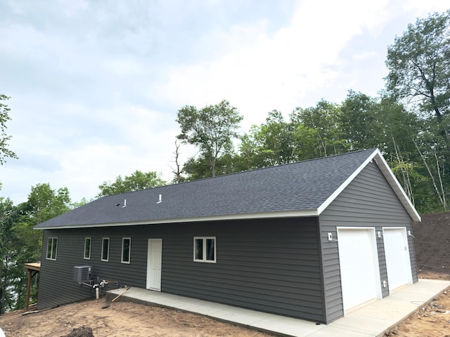 17541 Mitchell Lake Rd, Fifty Lakes, MN 56448 - rear view of property with a shingled roof and a detached garage