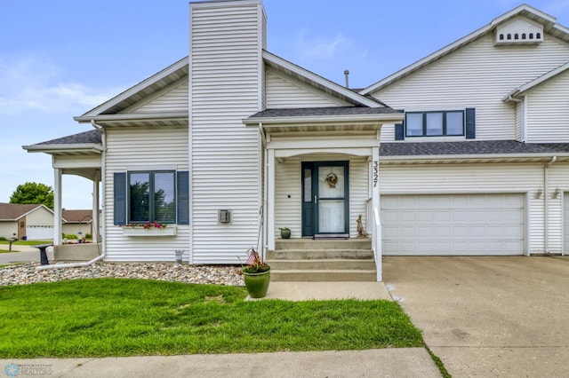3327 23rd Ave S, Fargo, ND 58103 - view of front facade with concrete driveway, a front lawn, a shingled roof, and a chimney