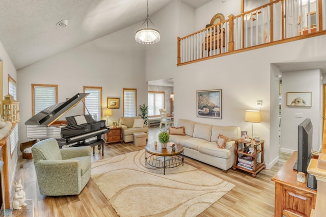 3327 23rd Ave S, Fargo, ND 58103 - living area featuring high vaulted ceiling, wood finished floors, and a chandelier