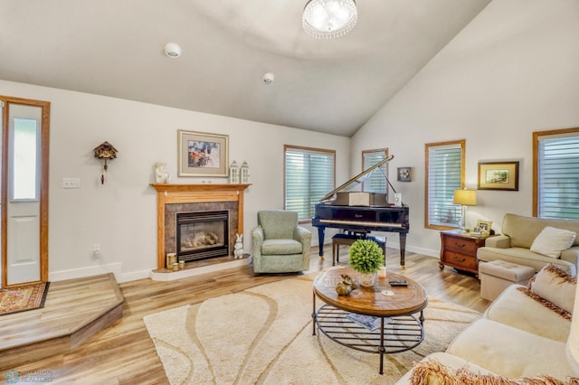 3327 23rd Ave S, Fargo, ND 58103 - living area featuring light wood finished floors, a fireplace, and high vaulted ceiling