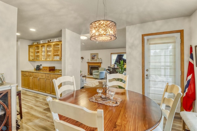 3327 23rd Ave S, Fargo, ND 58103 - dining room with light wood-type flooring, a fireplace, a chandelier, and recessed lighting